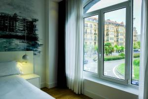 Postel nebo postele na pokoji v ubytování Boulevart Donostia