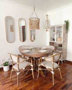 a dining room with a table and chairs and mirrors at Merendero de Briz in Marín +29 photos