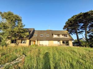 a house on top of a grassy hill at Ker Ty Mor - Waterfront Family House in Port-Louis