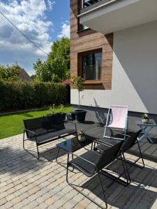 patio z krzesłami i stołem na patio w obiekcie Apartament Ósemka w mieście Mikołajki