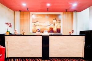 a counter with a picture of a bridge on the wall at Collection O Hotel Promenade Cihampelas in Bandung