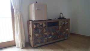 a refrigerator sitting on top of a wooden dresser at Terra Vitale in Cava deʼ Tirreni