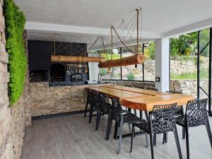 a dining room with a wooden table and chairs at La Piticu in Dubova