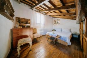 a bedroom with a bed and a desk and a table at Seaside Wooden Cottage Retreat in Karfas