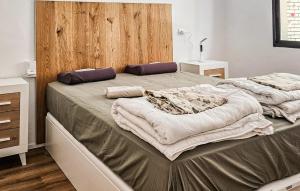 a bedroom with two beds and a wooden headboard at Gorgeous Apartment In Fuengirola in Fuengirola