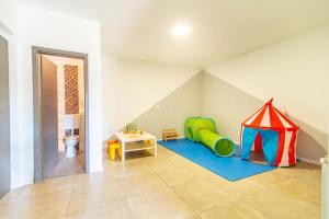 a room with a play room with a tent at Villa Zupan by Villa Plus in Vranići