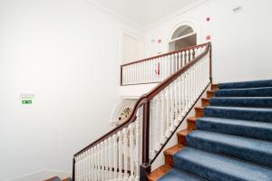 a staircase in a home with blue stairs at Bright Flat in Historic Foz House by HostWise in Porto