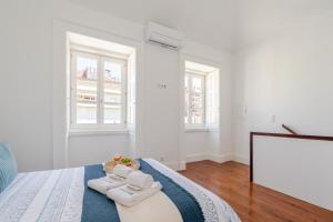 a bedroom with a bed with two towels on it at Bright Flat in Historic Foz House by HostWise in Porto +31 photos