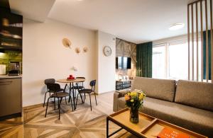 a living room with a couch and a table at Comfortable apartment, sauna Żywiec Lake in Zarzecze