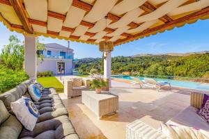 een villa met een zwembad en een patio bij Villa Tila by Villa Plus in Agnítsini