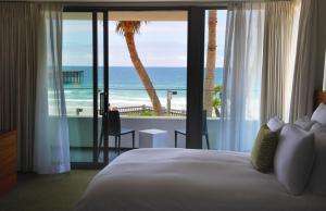 a bedroom with a bed and a view of the ocean at Tower 23 Hotel in San Diego