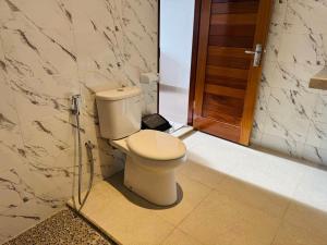 a bathroom with a toilet and a glass door at Villa in Ubud +9 photos