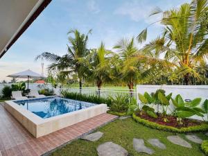 a backyard with a swimming pool and palm trees at Villa in Ubud