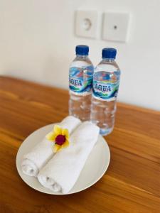 a plate with two bottles of water and a flower at Villa in Ubud