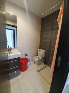 a bathroom with a toilet and a sink and a shower at Damac Hills 2- 3BR Townhouse - Homeyvillas in Dubai
