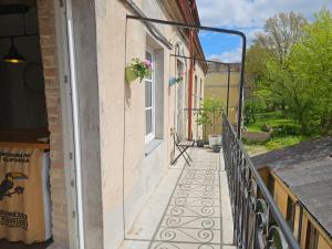 a balcony of a house with a window at Paupio Gertruda in Vilnius +5 photos