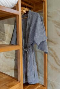 a shirt is hanging on a wooden shelf at Ten Moons Sunset Villas in Ko Lipe +46 photos