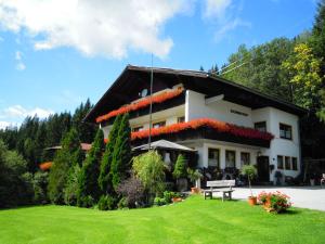 a house with a bench in front of it at Pension Sonnhof in Radstadt