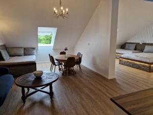 a living room with a table and a couch at Gørdinglund Herregård Bed & Breakfast in Gørding