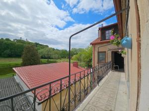 a balcony of a house with a roof at Paupio Gertruda in Vilnius