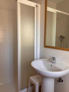 a bathroom with a sink and a mirror at Hostal Las Dunas in El Cabo de Gata