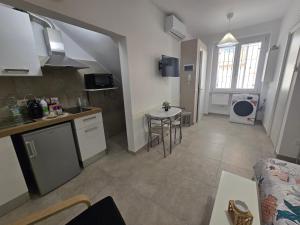 a kitchen and a living room with a table and a counter at Maclas Apartment -Vasto Centro Storico- in Vasto