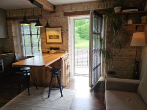 a kitchen with a wooden counter and a large window at Paupio Gertruda in Vilnius