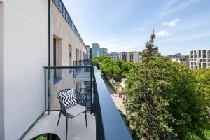 a balcony with a chair on a building at City Center Apartamentai Šatrijos g in Vilnius