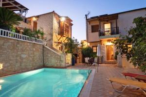 a swimming pool in front of a house at Mountain View Villa, by the Pool,Aris in Próvarma