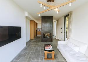 a living room with a white couch and a tv at Casa Via Costa in Ischia
