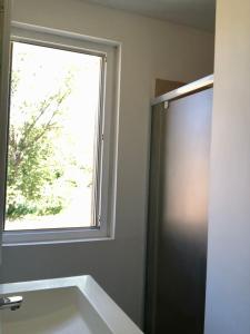 a bathroom with a window and a sink at La Maison de l'Aqueduc in Cournanel