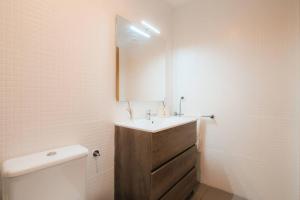 a bathroom with a sink and a mirror at Casa Augusta Renovada Centro Histórico 5 Pax in Zaragoza +33 photos