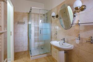 a bathroom with a glass shower and a sink at Villa de la Cloche by Villa Plus in Pouzolles +27 photos