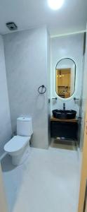 a bathroom with a toilet and a mirror at Apartment in Didi Digomi in Tbilisi City