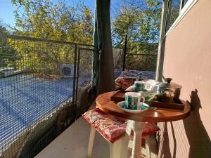 - une table sur un balcon avec vue sur un court de tennis dans l'établissement Mi alma deptos, à Mendoza 6 autres photos