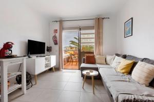 a living room with a couch and a tv at Casa Nicole Sea View in Costa de Antigua