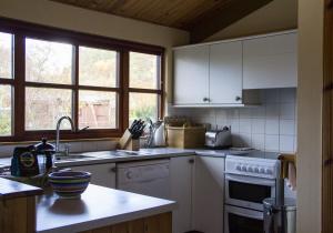 a kitchen with a sink and a stove top oven at Rhum Lodge in Duirinish +1 photo