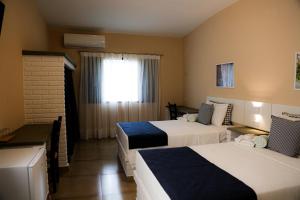 Postel nebo postele na pokoji v ubytování Matiz Igaratá Resort, Spa e Eventos + 37 fotografií