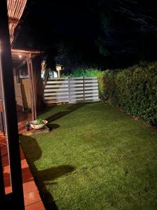 a backyard at night with a fence and grass at Casa Capinera in Pula