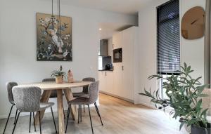 a kitchen and dining room with a table and chairs at 2 Bedroom Amazing Home In Hellendoorn in Hellendoorn