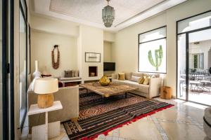 a living room with a couch and a table at Riad Malaika in Marrakech