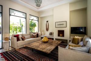 a living room with a couch and a table at Riad Malaika in Marrakech