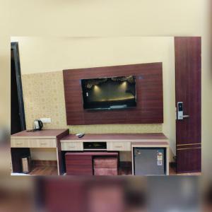 a room with a flat screen tv on a wall at Pink Mahal Hotel & Resort in Jaipur