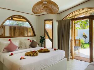 a bedroom with a bed with towels on it at You & Me Private Villa in Gili Islands