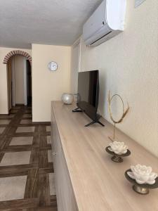 a living room with a flat screen tv on a counter at Appartamento Aurora in Orosei