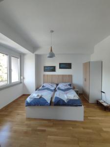 a bedroom with a bed in a white room at Studio Sara in Ohrid