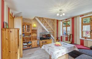 a living room with a table and a staircase at Ferienwohnung Bodstedt in Bodstedt