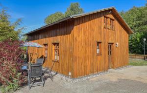 a wooden building with a table and an umbrella at Ferienwohnung Bodstedt in Bodstedt +22 photos