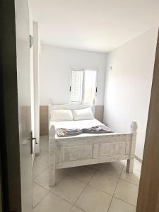 a white bed in a room with a window at Blue Oceano in Santa Maria +13 photos