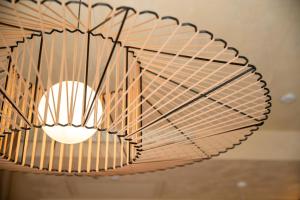 a light fixture hanging from a ceiling at Cala Ponte, a Tribute Portfolio Hotel in Polignano a Mare